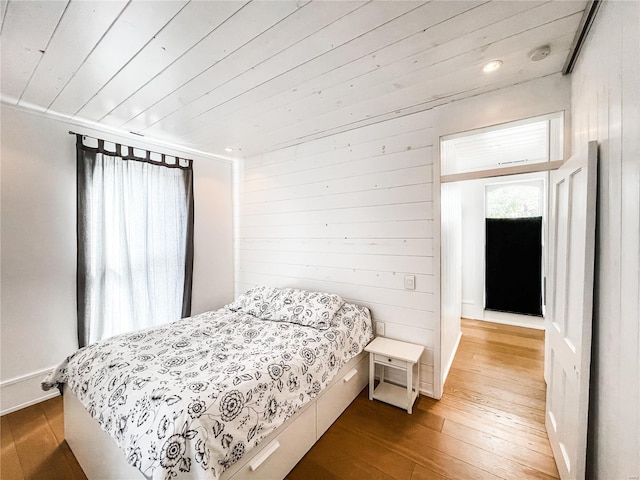 bedroom featuring hardwood / wood-style floors and wood ceiling