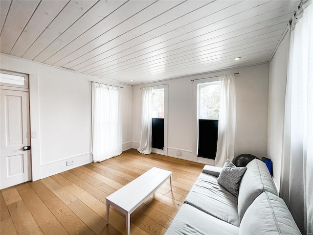 living room featuring light hardwood / wood-style floors and wood ceiling