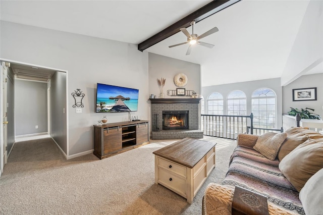 living area with beam ceiling, light carpet, a ceiling fan, baseboards, and a brick fireplace