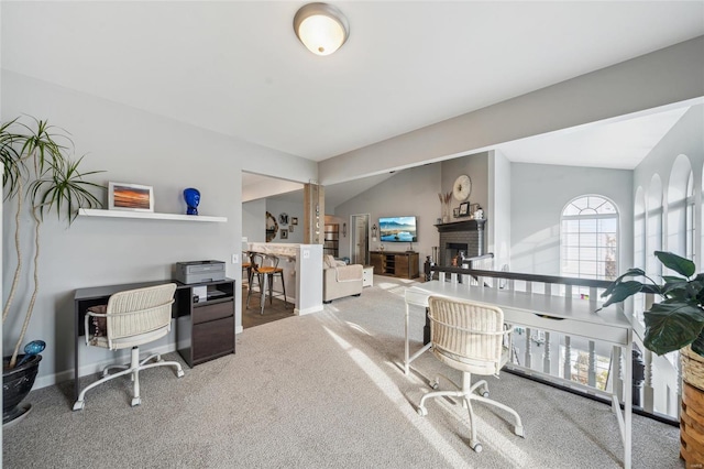 carpeted office with baseboards and a brick fireplace