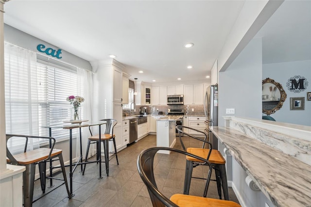 dining area with recessed lighting and light tile patterned flooring