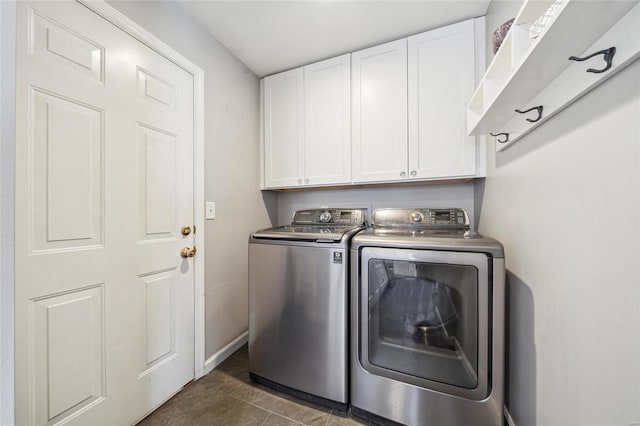 laundry room featuring cabinet space, baseboards, and separate washer and dryer