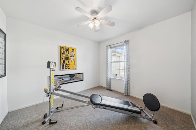 exercise area with baseboards and ceiling fan