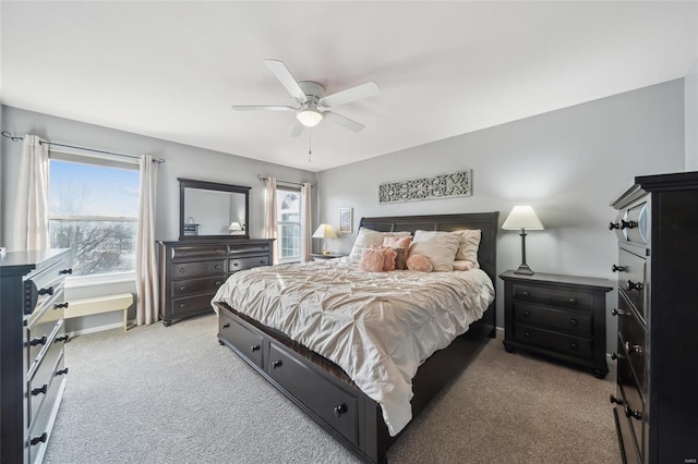 bedroom featuring light carpet, a ceiling fan, and baseboards