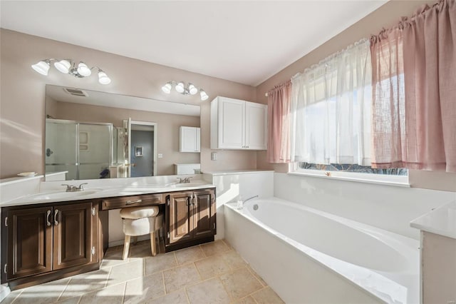 full bathroom featuring a stall shower, a bath, visible vents, and a sink