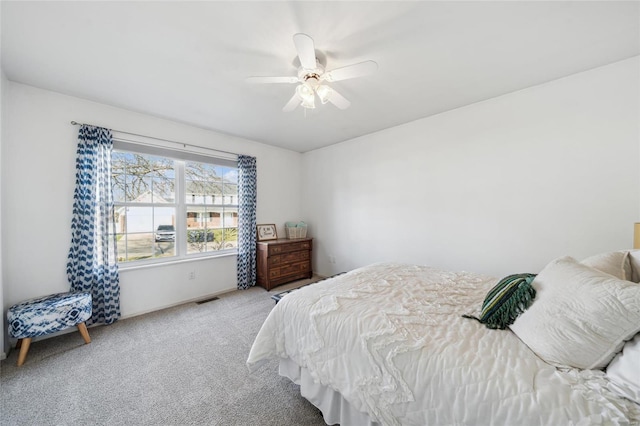 bedroom with visible vents, carpet floors, and a ceiling fan