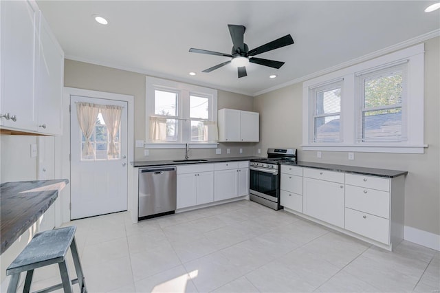 kitchen featuring white cabinetry, sink, appliances with stainless steel finishes, ceiling fan, and crown molding