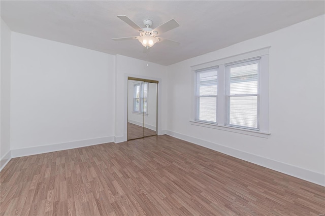 unfurnished room with hardwood / wood-style flooring and ceiling fan