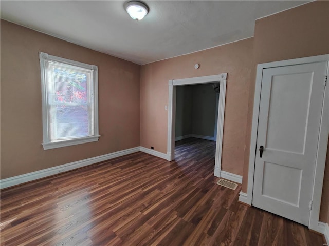 empty room featuring dark hardwood / wood-style flooring