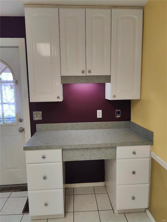 kitchen featuring white cabinetry and light tile patterned floors