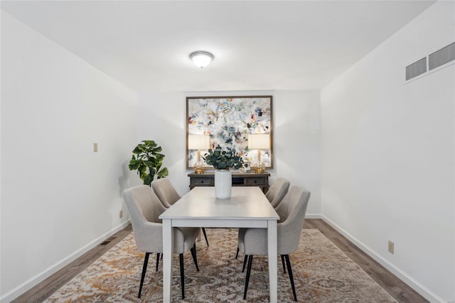 dining space with hardwood / wood-style floors