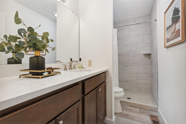 bathroom featuring hardwood / wood-style floors, vanity, toilet, and a shower with curtain