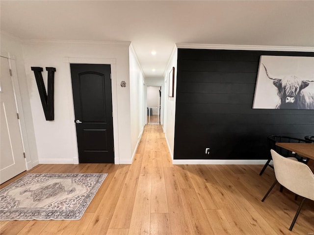 hall featuring light hardwood / wood-style flooring and ornamental molding