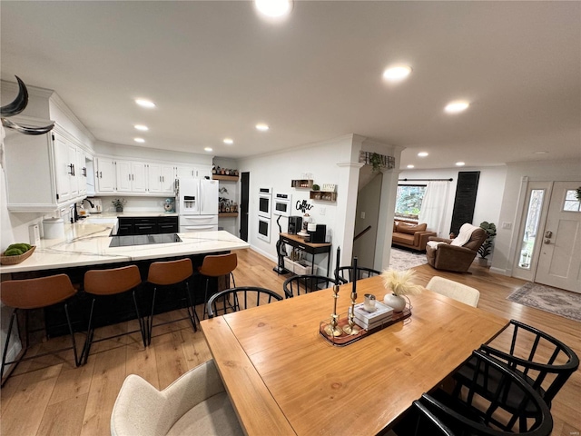 dining space featuring sink and light hardwood / wood-style floors