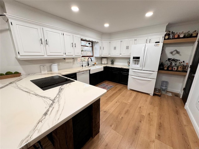 kitchen with light wood-type flooring, stainless steel dishwasher, sink, white cabinets, and white fridge with ice dispenser