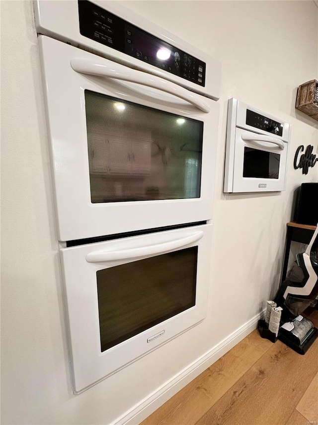 interior details featuring light hardwood / wood-style floors and double oven