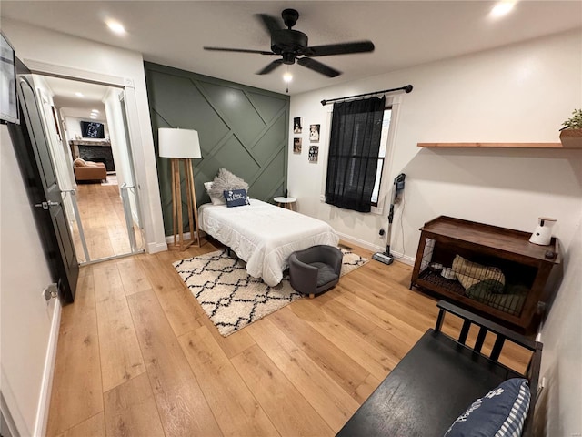 bedroom featuring light hardwood / wood-style floors and ceiling fan