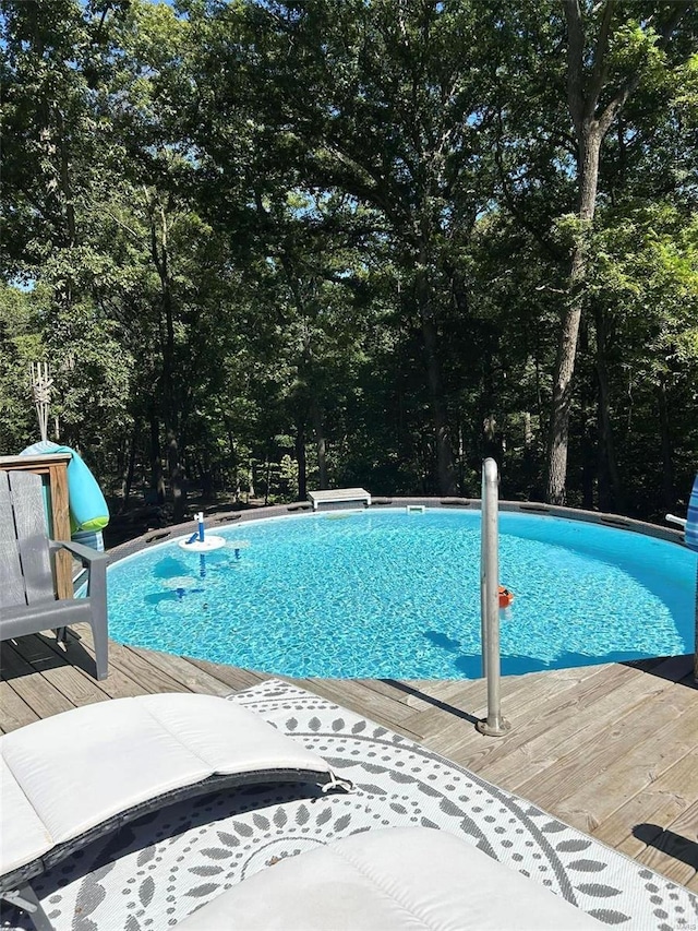 view of swimming pool with a deck