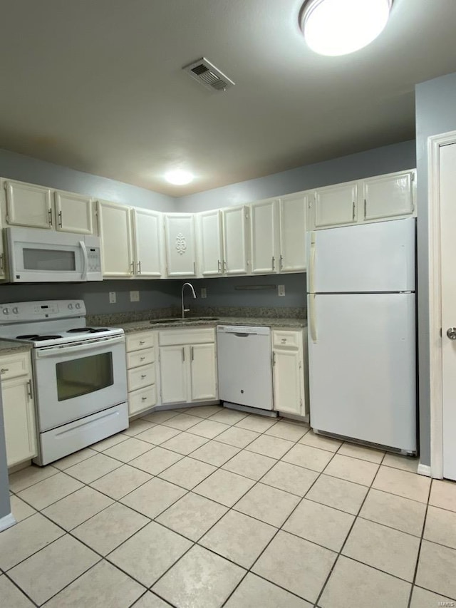 kitchen featuring white cabinetry, white appliances, light tile patterned flooring, and sink