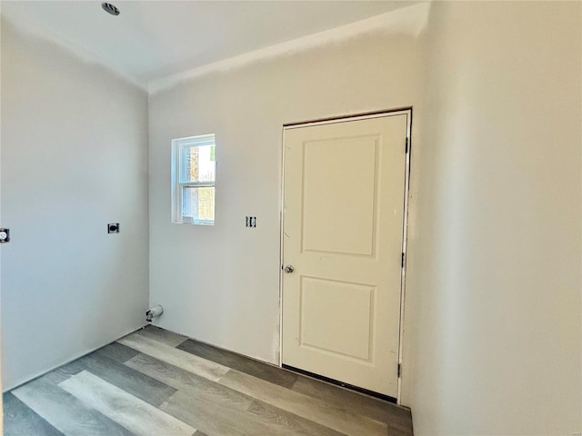 laundry room with hookup for an electric dryer, laundry area, and light wood finished floors