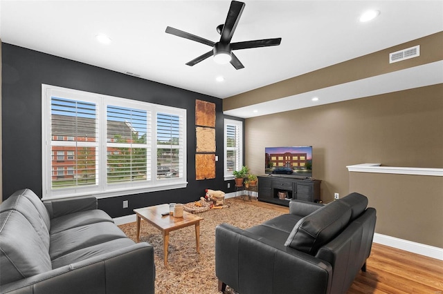 living room with hardwood / wood-style floors and ceiling fan