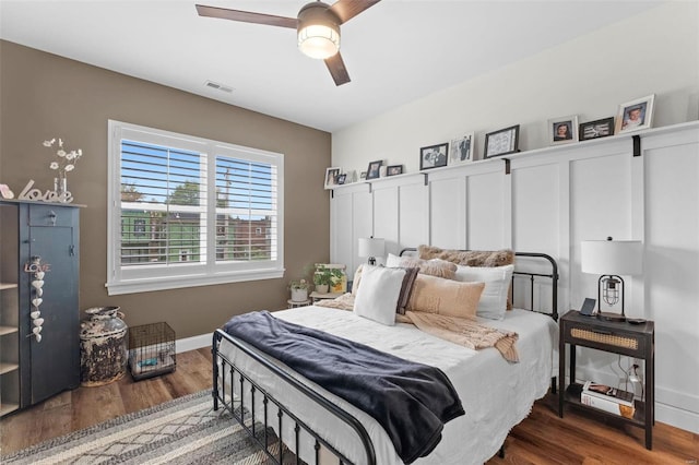 bedroom with dark hardwood / wood-style flooring and ceiling fan