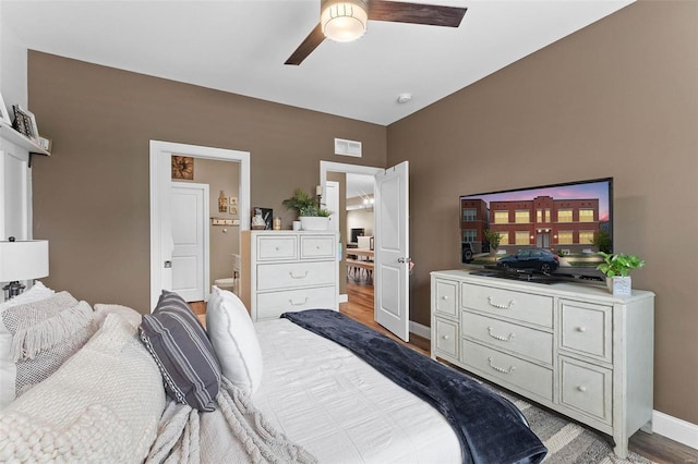 bedroom with connected bathroom, light hardwood / wood-style floors, and ceiling fan