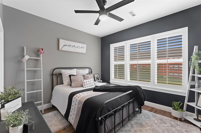 bedroom with hardwood / wood-style floors and ceiling fan