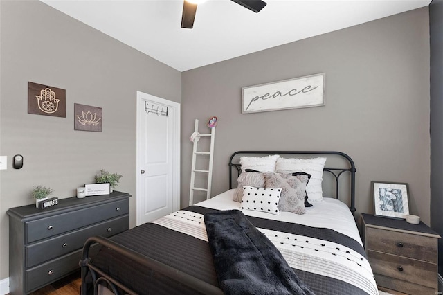 bedroom with dark wood-type flooring and ceiling fan