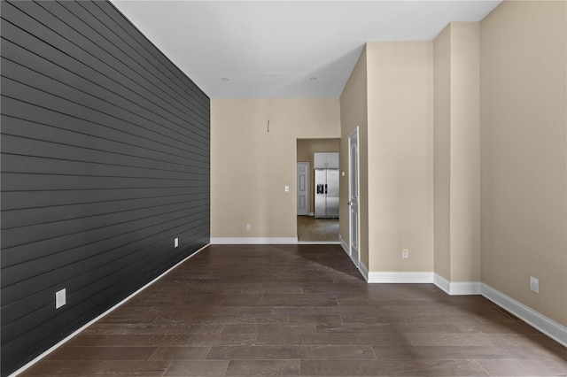 empty room with dark hardwood / wood-style flooring