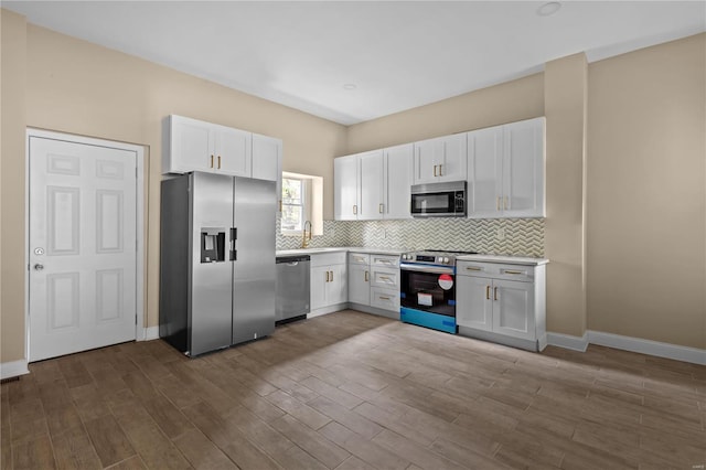 kitchen featuring white cabinetry, appliances with stainless steel finishes, and wood-type flooring