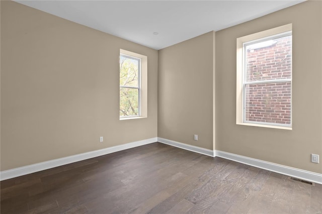 empty room featuring dark hardwood / wood-style flooring