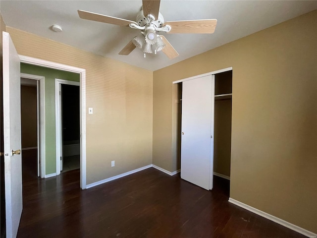 unfurnished bedroom with ceiling fan, dark hardwood / wood-style floors, and a closet