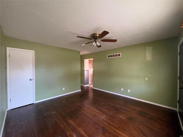 spare room featuring dark wood-type flooring and ceiling fan