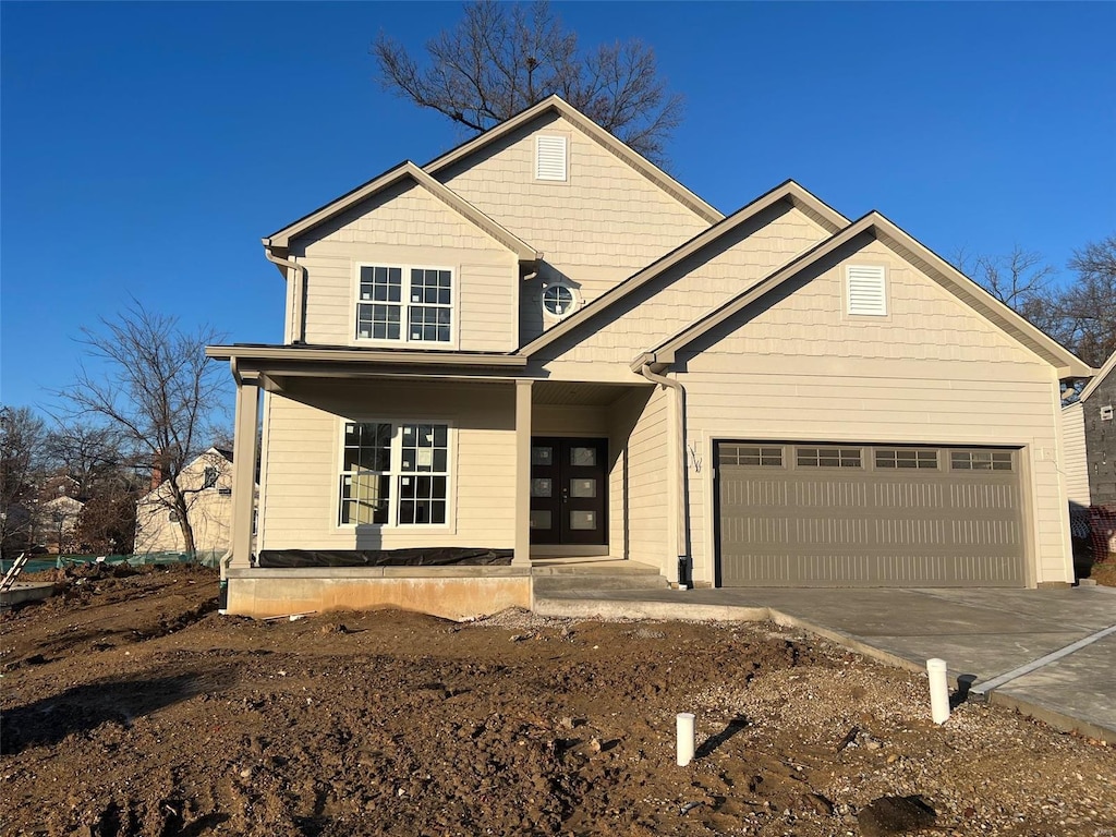 view of front facade featuring a porch and a garage