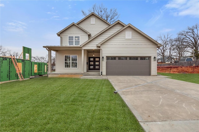 view of front of house featuring a garage, french doors, and a front lawn