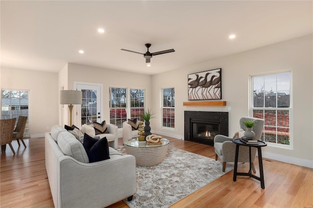 living room with ceiling fan and light hardwood / wood-style floors