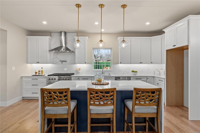 kitchen with wall chimney exhaust hood, a center island, and white cabinets