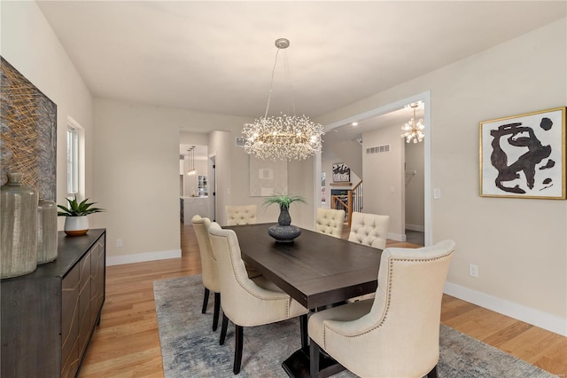 dining room featuring an inviting chandelier and light hardwood / wood-style floors