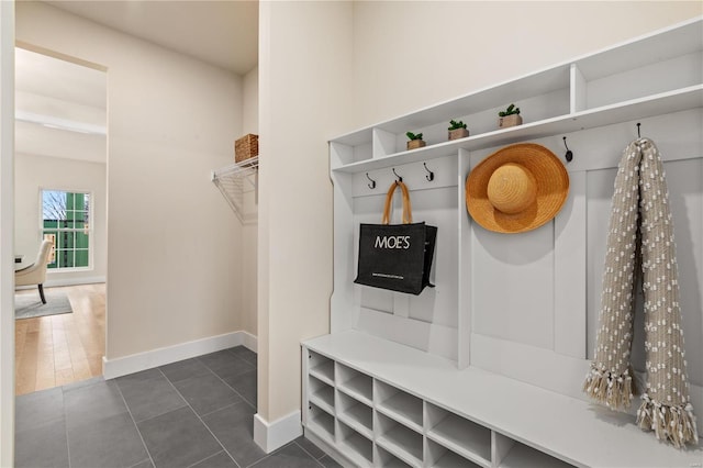 mudroom featuring dark tile patterned flooring