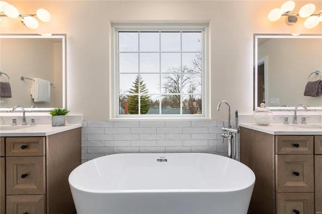 bathroom with vanity, a bathtub, and tile walls