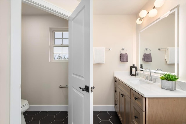 bathroom with tile patterned flooring, vanity, and toilet