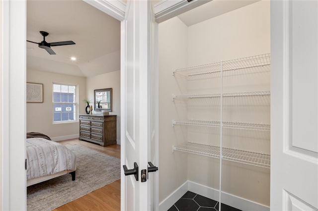 interior space featuring ceiling fan, lofted ceiling, and wood-type flooring