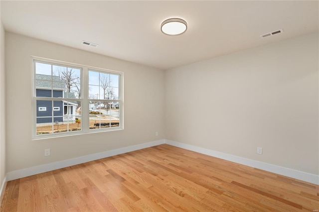 unfurnished room with light hardwood / wood-style floors