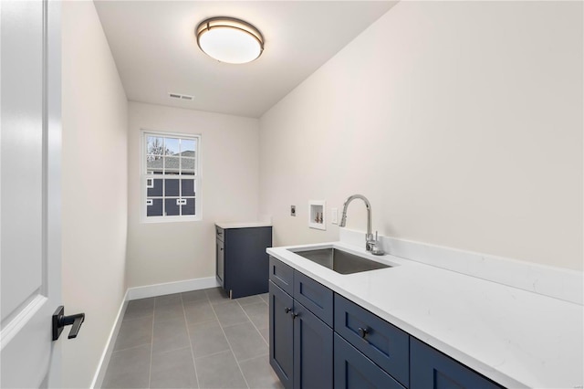 clothes washing area featuring light tile patterned flooring, sink, cabinets, washer hookup, and hookup for an electric dryer