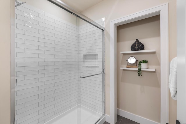 bathroom featuring tile patterned flooring and a shower with shower door