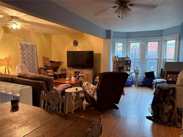 living room featuring hardwood / wood-style flooring and ceiling fan