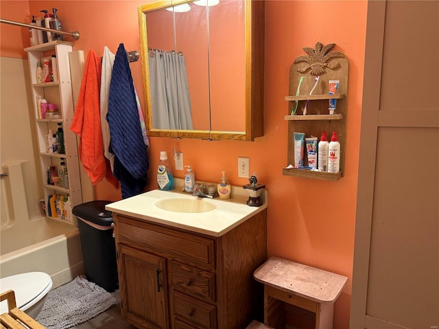 full bathroom featuring vanity, toilet, and shower / tub combo