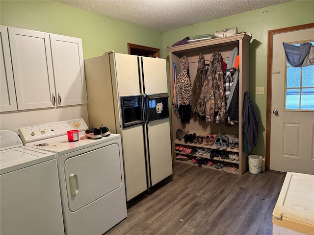 laundry room featuring cabinets, washing machine and dryer, a textured ceiling, and dark hardwood / wood-style floors