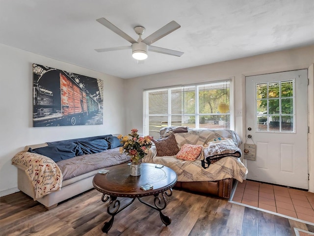 living room with dark wood-type flooring and ceiling fan